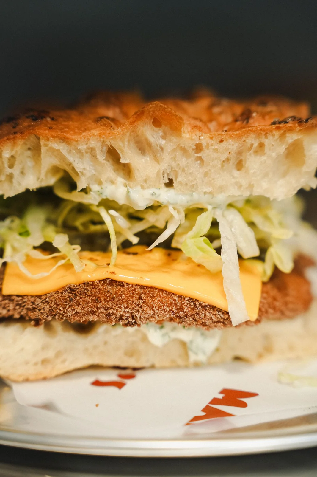 A chicken schnitzel focaccia on a Mamma G's branded plate