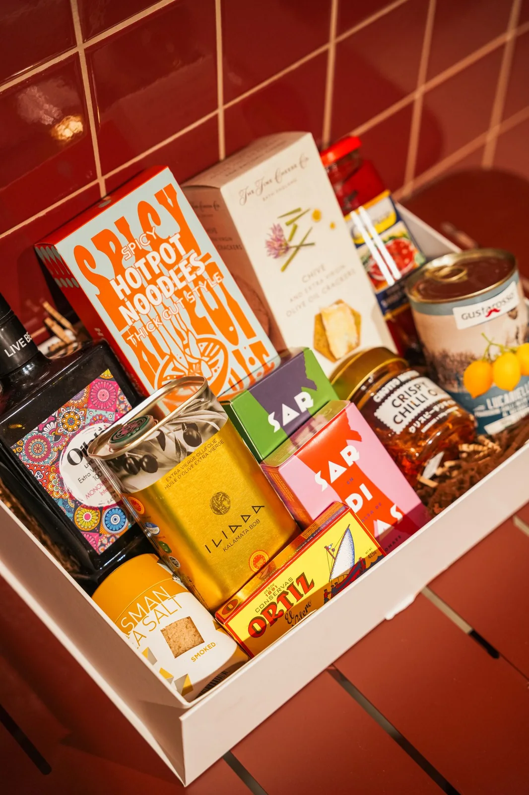 An open Mamma G's hamper packed with chocolate, biscuits, preserves, nuts and pantry goods