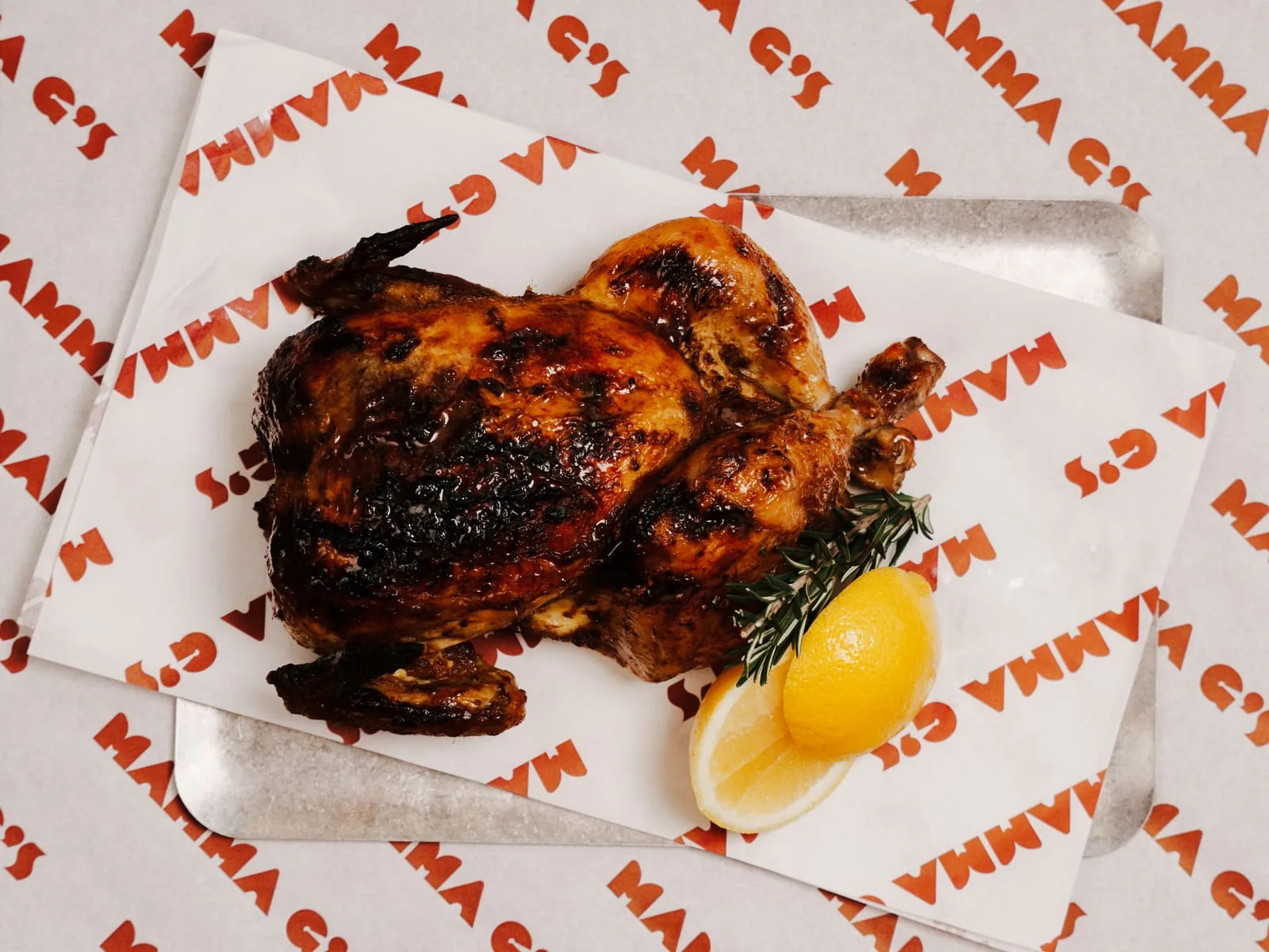 A whole roast chicken on Mamma G's branded wrapping paper